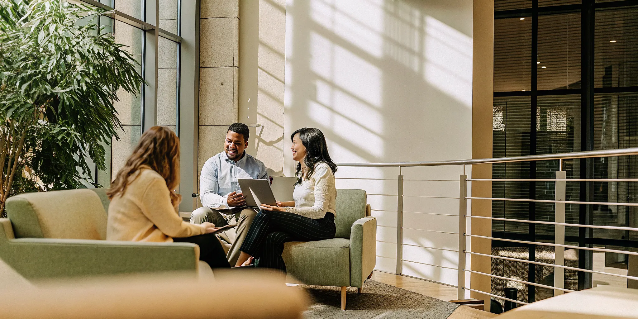 Washington health insurance account manager consulting with a small business team in a modern office